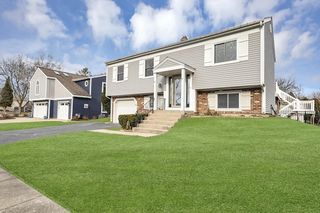 bi-level home featuring a garage and a front yard