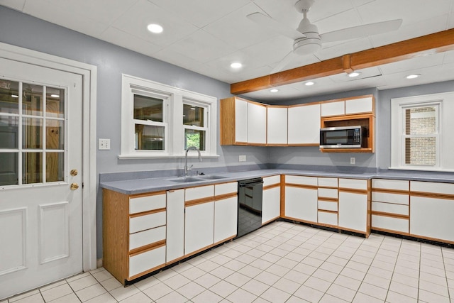 kitchen featuring sink, white cabinets, dishwasher, light tile patterned floors, and beam ceiling