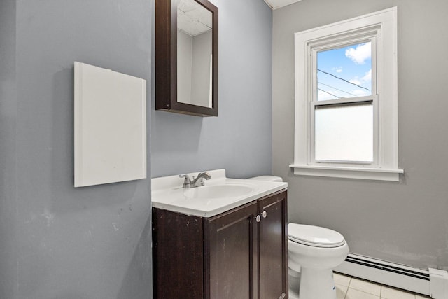 bathroom featuring tile patterned floors, toilet, vanity, and a baseboard heating unit