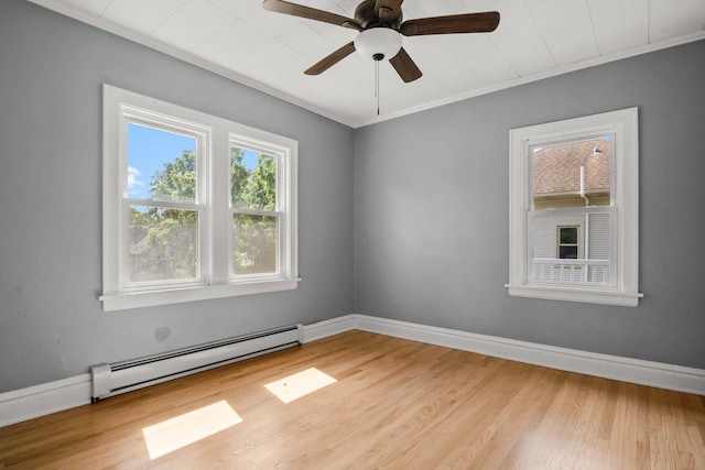 unfurnished room featuring a baseboard heating unit, light wood-type flooring, and crown molding