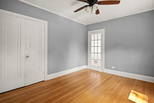 unfurnished bedroom featuring ceiling fan, hardwood / wood-style floors, and a closet