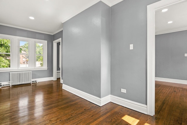 unfurnished room featuring crown molding, dark wood-type flooring, and radiator