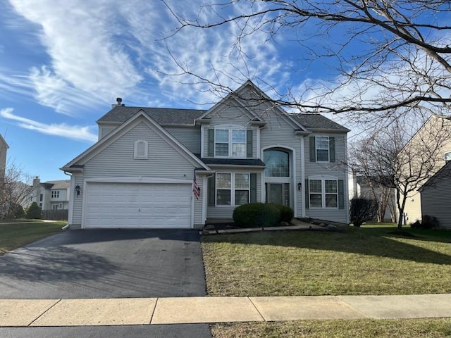 view of front property with a garage and a front lawn