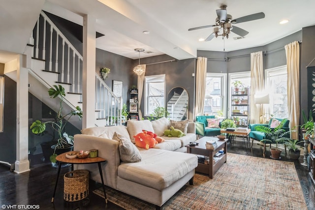 living room featuring ceiling fan and hardwood / wood-style flooring