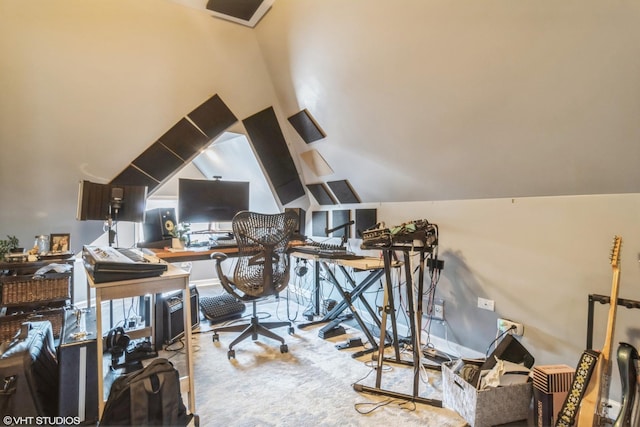 carpeted home office featuring lofted ceiling