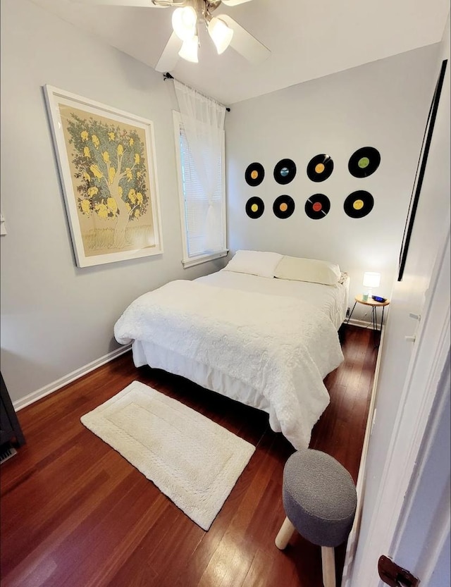 bedroom featuring ceiling fan and dark hardwood / wood-style flooring