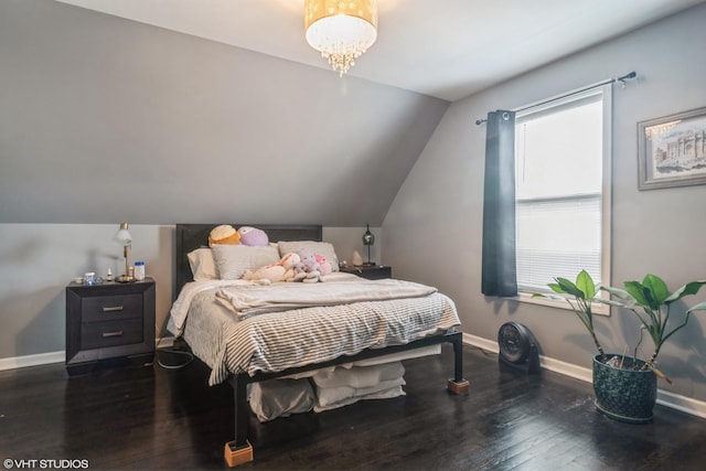 bedroom featuring dark wood-type flooring and lofted ceiling