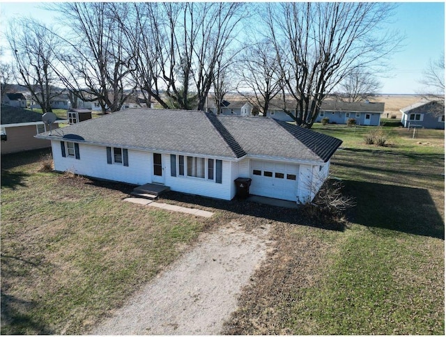 ranch-style home featuring a garage and a front lawn