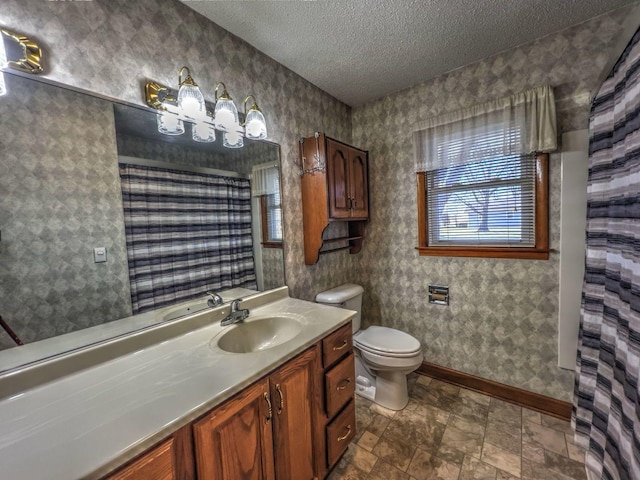 bathroom featuring vanity, toilet, and a textured ceiling