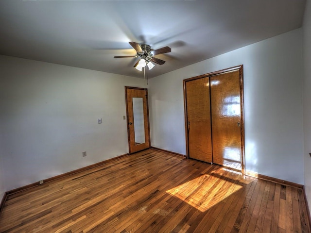 unfurnished bedroom featuring a closet, dark hardwood / wood-style floors, and ceiling fan