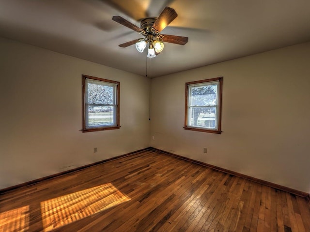 spare room with ceiling fan, plenty of natural light, and hardwood / wood-style floors