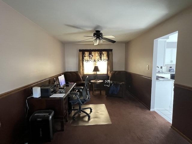 carpeted office featuring ceiling fan