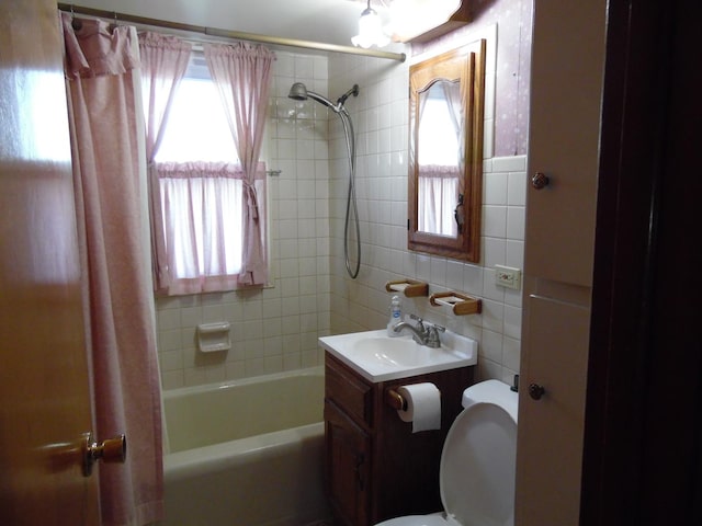 full bathroom with toilet, shower / bathtub combination with curtain, tile walls, and vanity