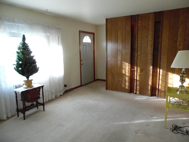 foyer entrance featuring light colored carpet