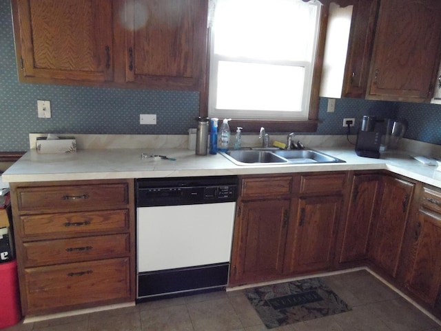 kitchen with sink, tile patterned floors, tasteful backsplash, and dishwasher