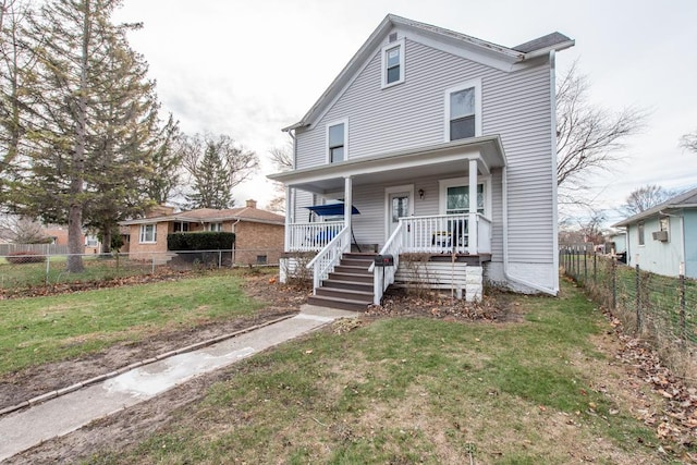 view of front of home with covered porch and a front lawn