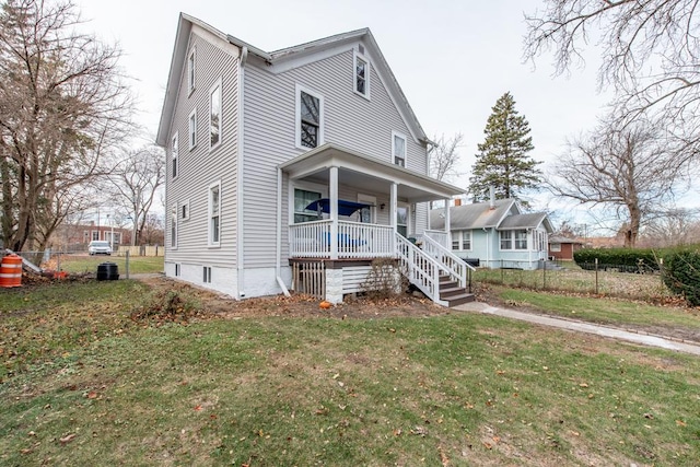 view of front of property featuring covered porch and a front lawn