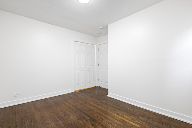 spare room with dark hardwood / wood-style flooring