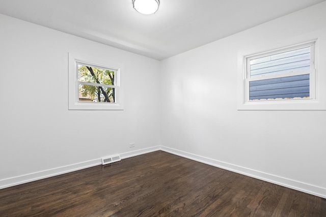 unfurnished room featuring dark wood-type flooring