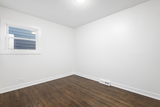 empty room with dark wood-type flooring