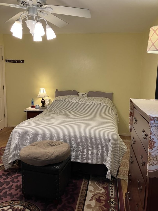 bedroom featuring dark wood-style floors, ceiling fan, and baseboards