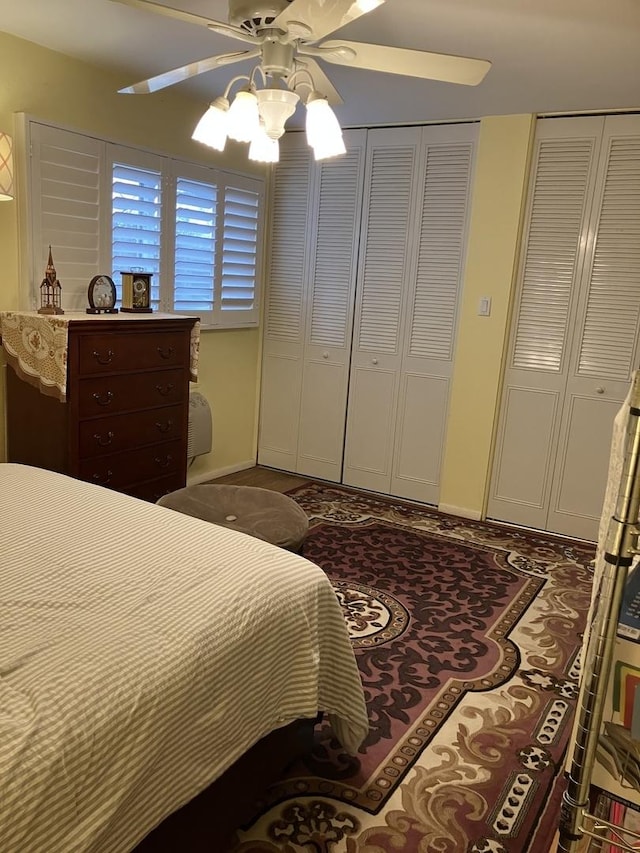 bedroom featuring ceiling fan and multiple closets