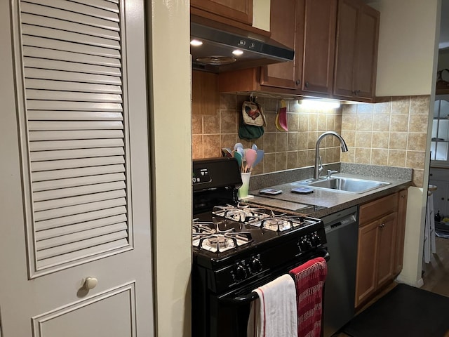 kitchen featuring tasteful backsplash, brown cabinets, black appliances, a sink, and exhaust hood