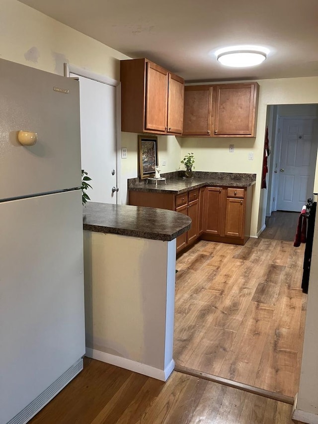 kitchen with wood walls and brown cabinetry