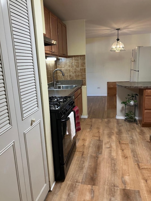 kitchen with brown cabinets and wood walls