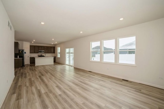 unfurnished living room featuring light hardwood / wood-style floors