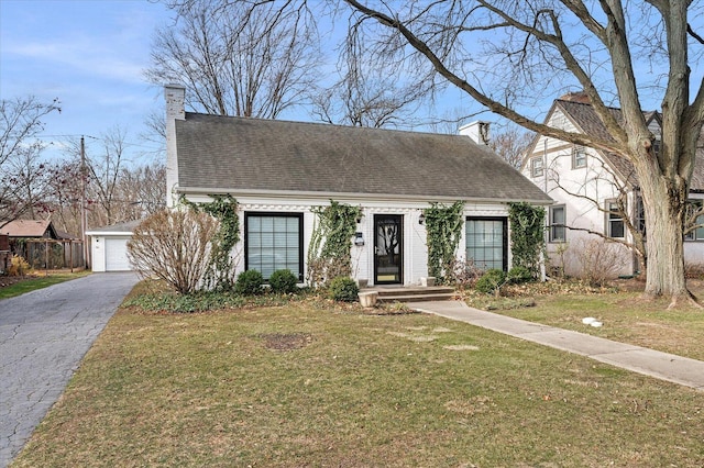 view of front of property with a garage and a front lawn