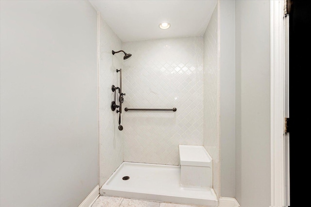 bathroom with tile patterned floors and tiled shower