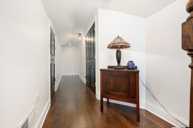 hall with dark hardwood / wood-style floors