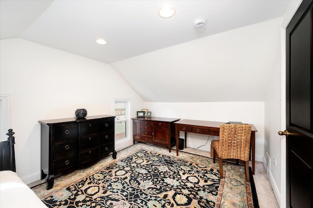 interior space with light carpet and vaulted ceiling