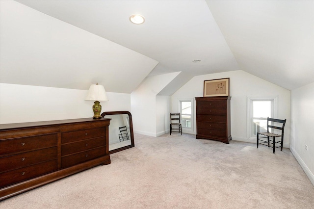 carpeted bedroom with lofted ceiling