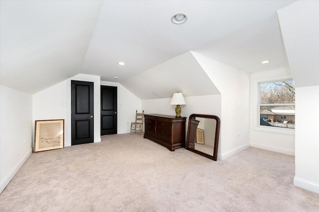 bonus room featuring light colored carpet and vaulted ceiling