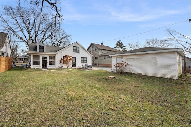 rear view of house with a patio area and a yard