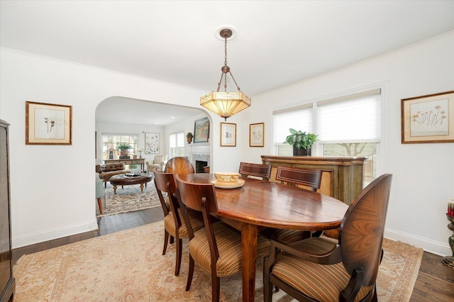 dining area featuring dark hardwood / wood-style floors and crown molding