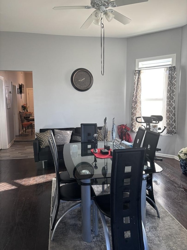 dining space featuring ceiling fan and dark hardwood / wood-style floors