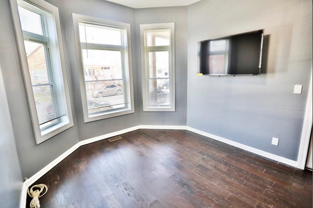 unfurnished room featuring dark wood-type flooring