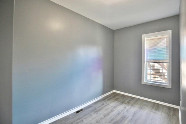 unfurnished room with wood-type flooring