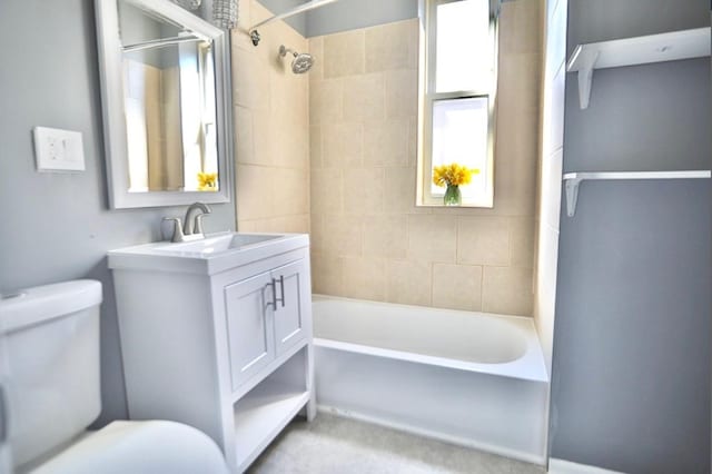 full bathroom featuring vanity, toilet, and tiled shower / bath