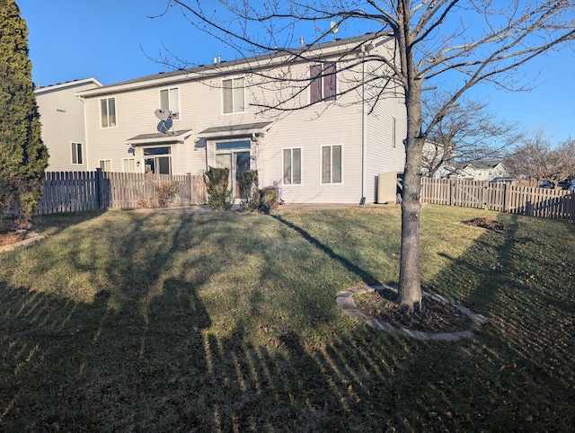 rear view of property with a lawn