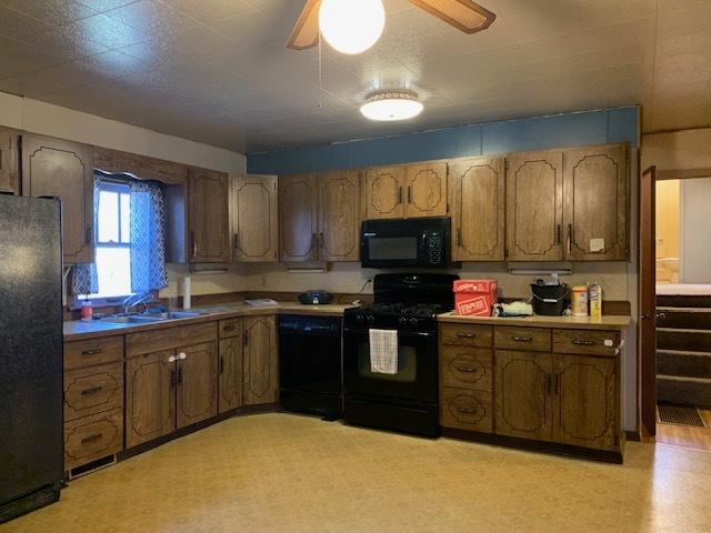 kitchen featuring ceiling fan, sink, and black appliances