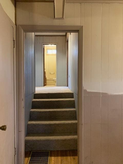 staircase with wood-type flooring