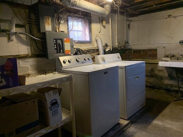 clothes washing area featuring separate washer and dryer