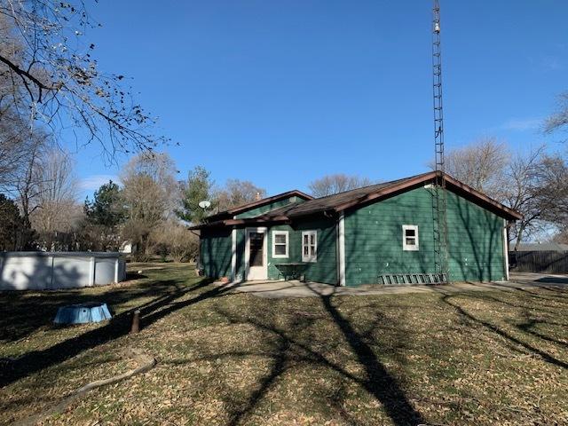 rear view of house featuring a yard