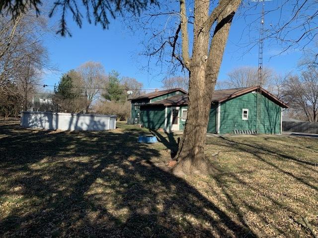 view of side of home featuring a yard