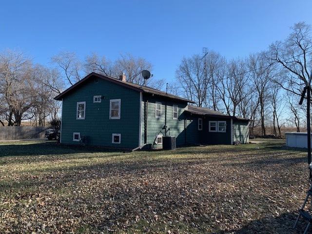 view of home's exterior with a yard and cooling unit