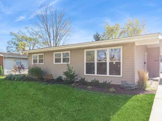 view of side of property with a lawn